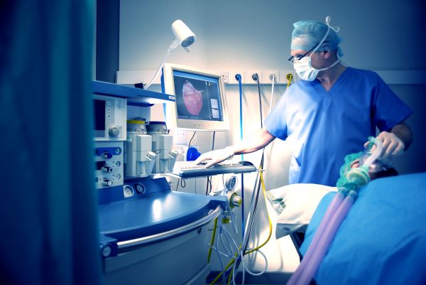 A doctor using ventilators to treat patient in ICU