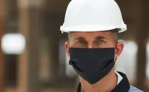 Maintenance engineer wearing PPE and face mask